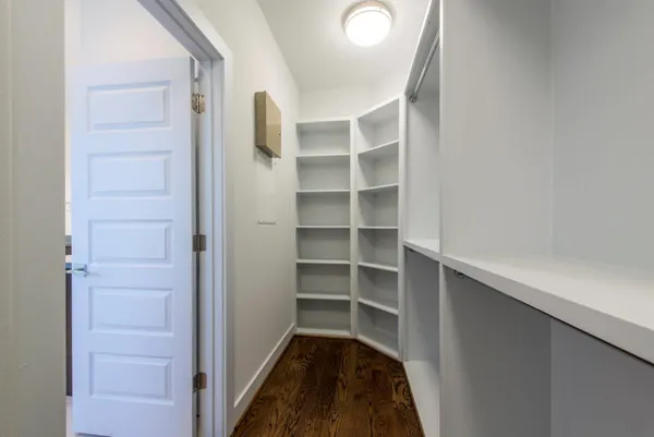 a view of walk in closet with empty racks
