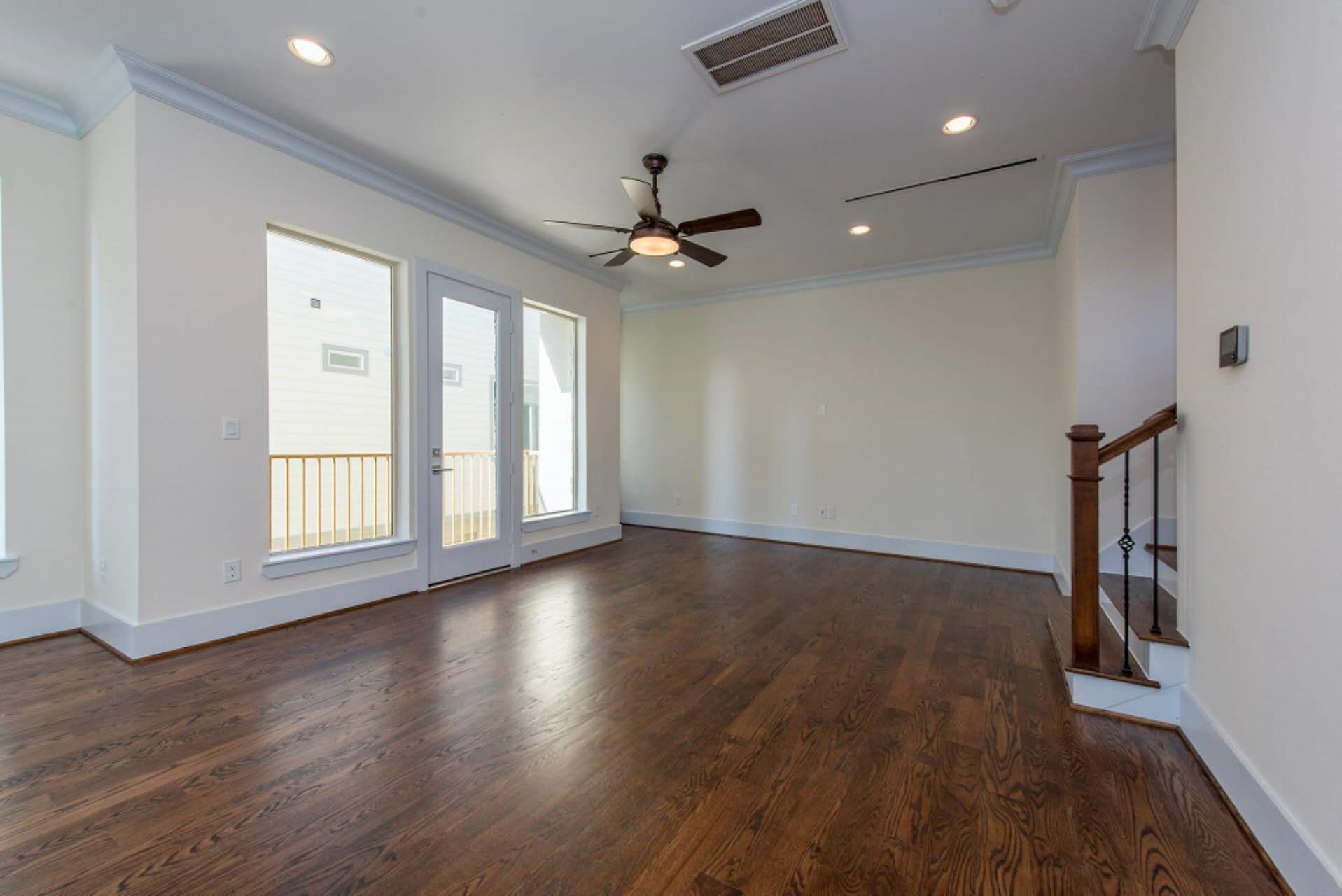 1805 Rosedale Street Houston, TX 77004 - Photo 3 of 27 a view of an empty room with wooden floor and a window