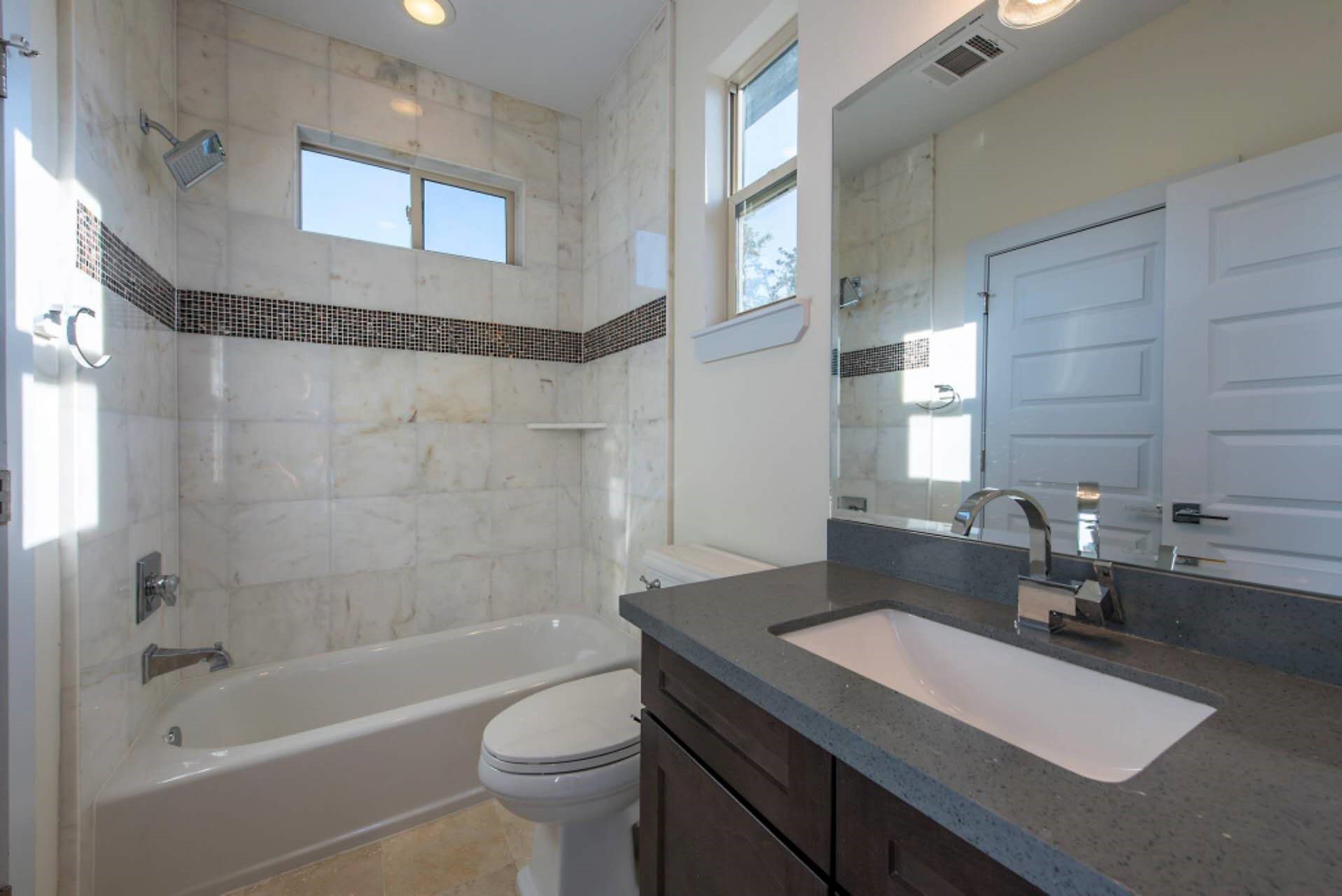 1805 Rosedale Street Houston, TX 77004 - Photo 6 of 27 a bathroom with a sink a toilet and shower
