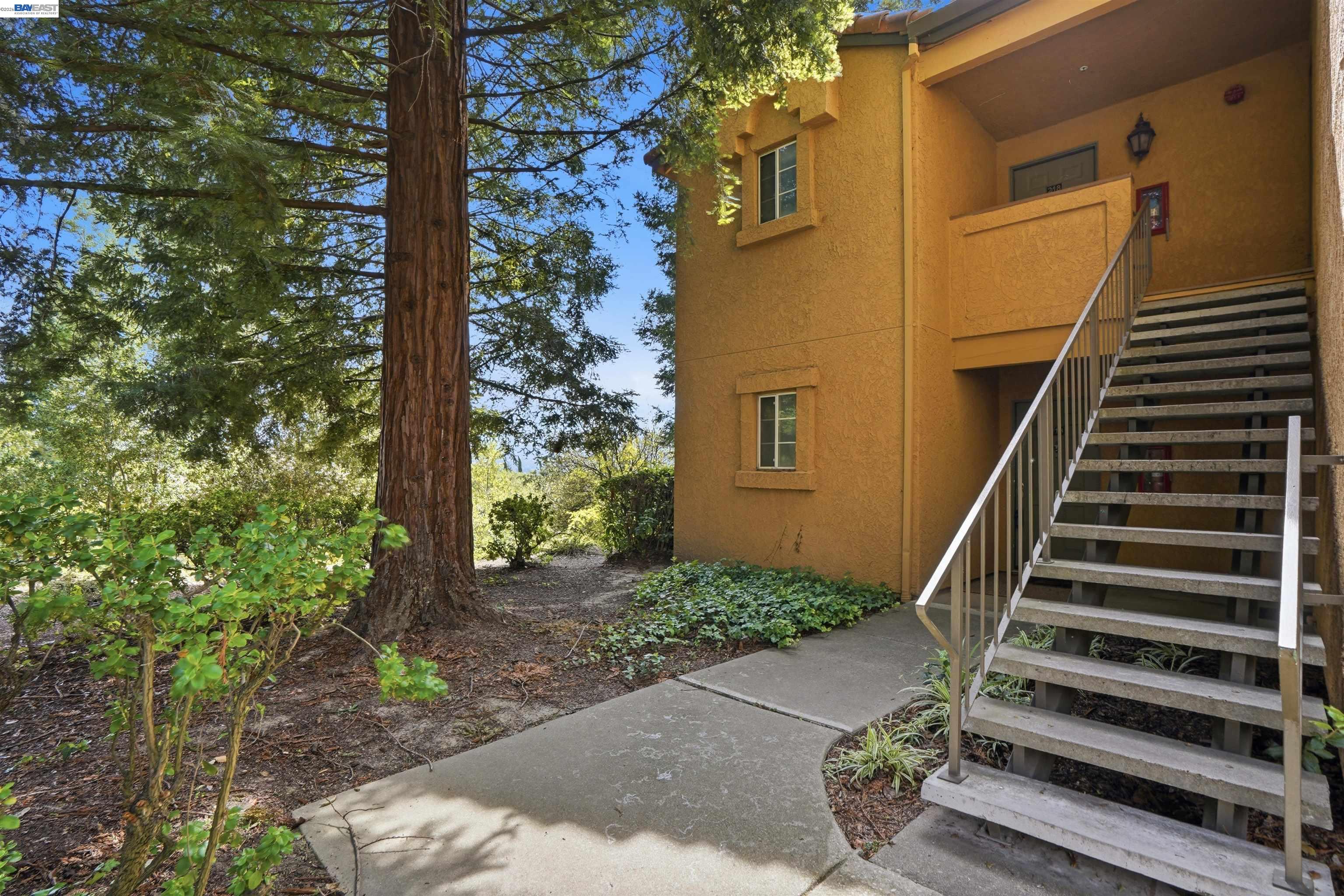 735 Watson Canyon Court, Unit 218 San Ramon, CA 94582 - Photo 16 of 18 a view of a house with backyard and trees