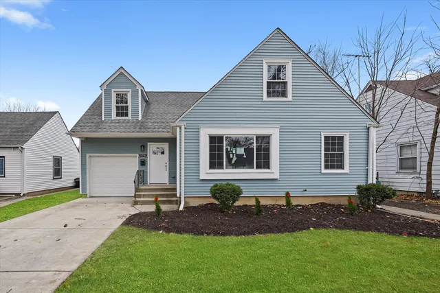 a front view of a house with a garden and plants