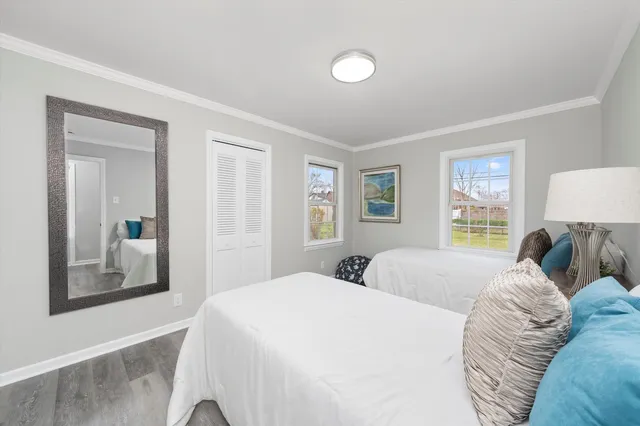 a bedroom with a large bed and a window