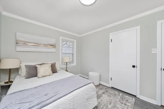 a bedroom with a bed and a night stand