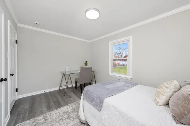 a bedroom with a bed and a table