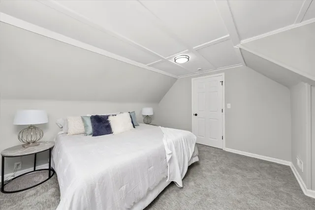 a bedroom with a bed and a lamp