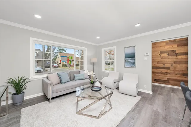 a living room with furniture and wooden floor