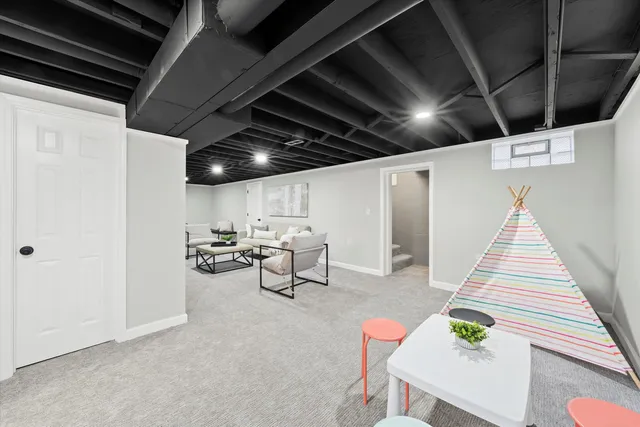 a living room with patio furniture and a wooden floor