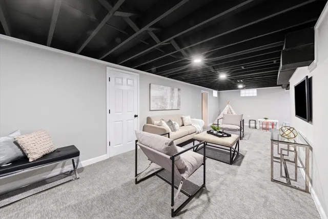 a living room with furniture and a potted plant