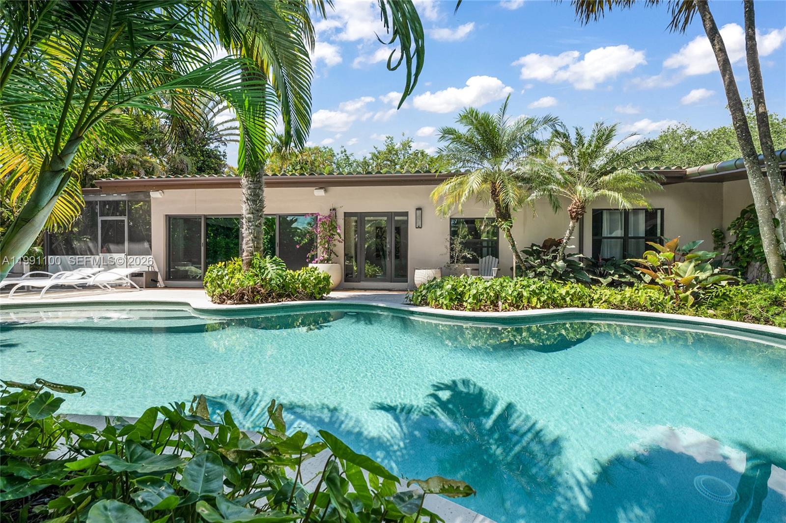 3620 Battersea Road Miami, FL 33133 - Photo 2 of 25 a front view of a house with swimming pool