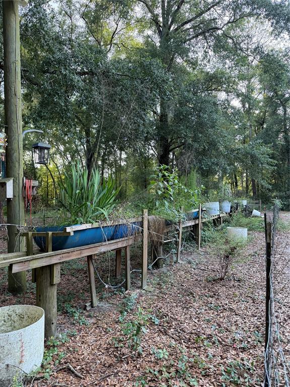 5109 Southwest 10th Street Bell, FL 32619 - Photo 15 of 38 a view of a wooden bench sitting in backyard