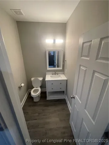 a bathroom with a sink a toilet and mirror