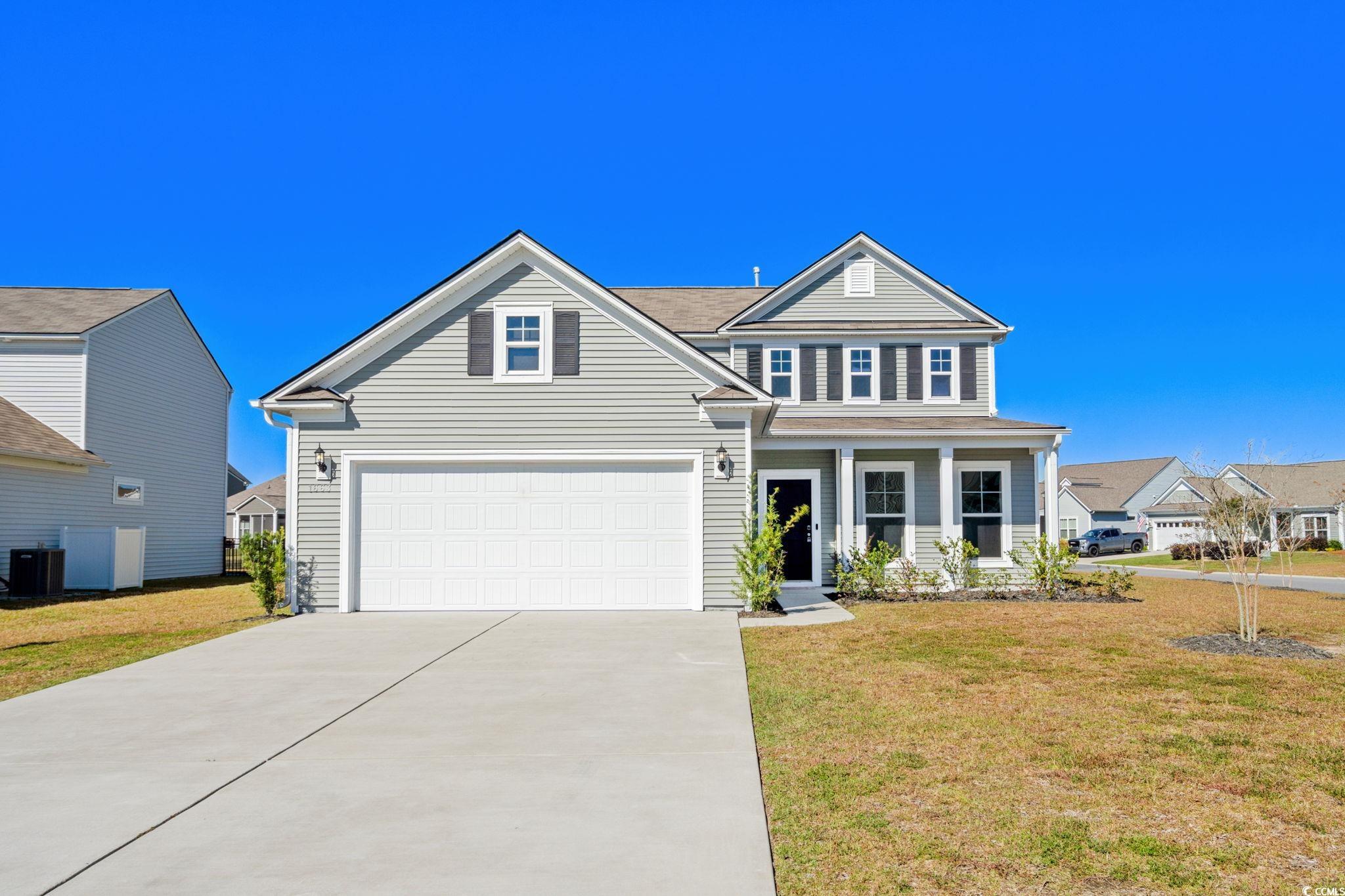 1663 Villena Drive Myrtle Beach, SC 29579 - Photo 1 of 40 Traditional home with a front yard, covered porch, and driveway