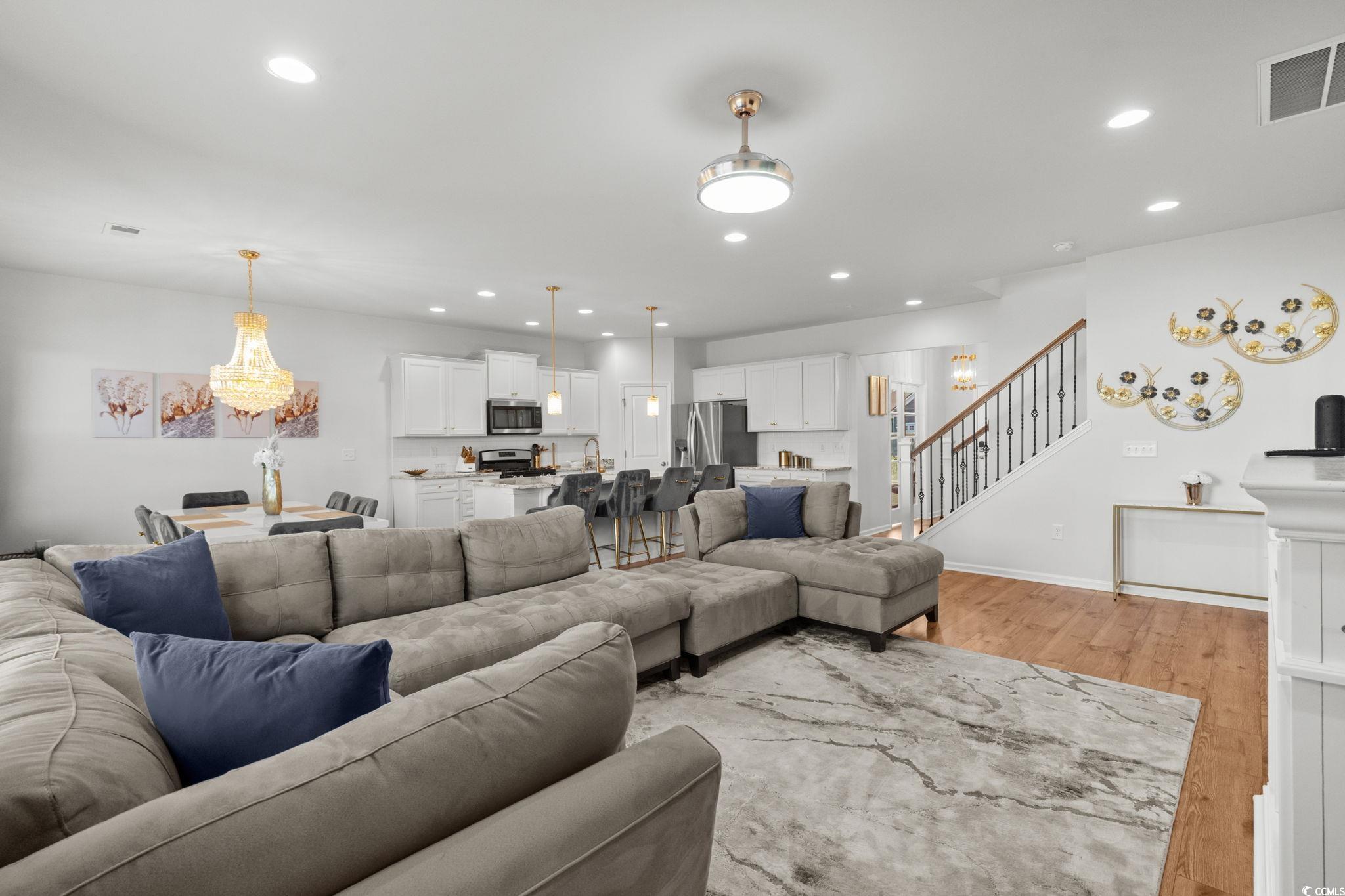 1663 Villena Drive Myrtle Beach, SC 29579 - Photo 11 of 40 Living room with light wood-style flooring, recessed lighting, stairs, and a chandelier