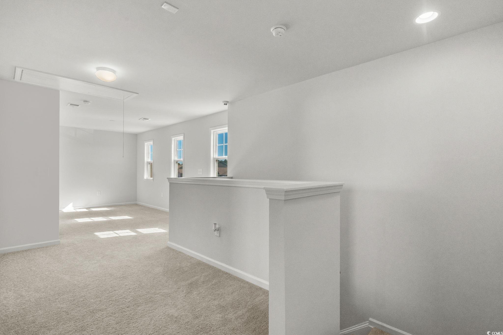1663 Villena Drive Myrtle Beach, SC 29579 - Photo 21 of 40 Spare room featuring attic access and light colored carpet