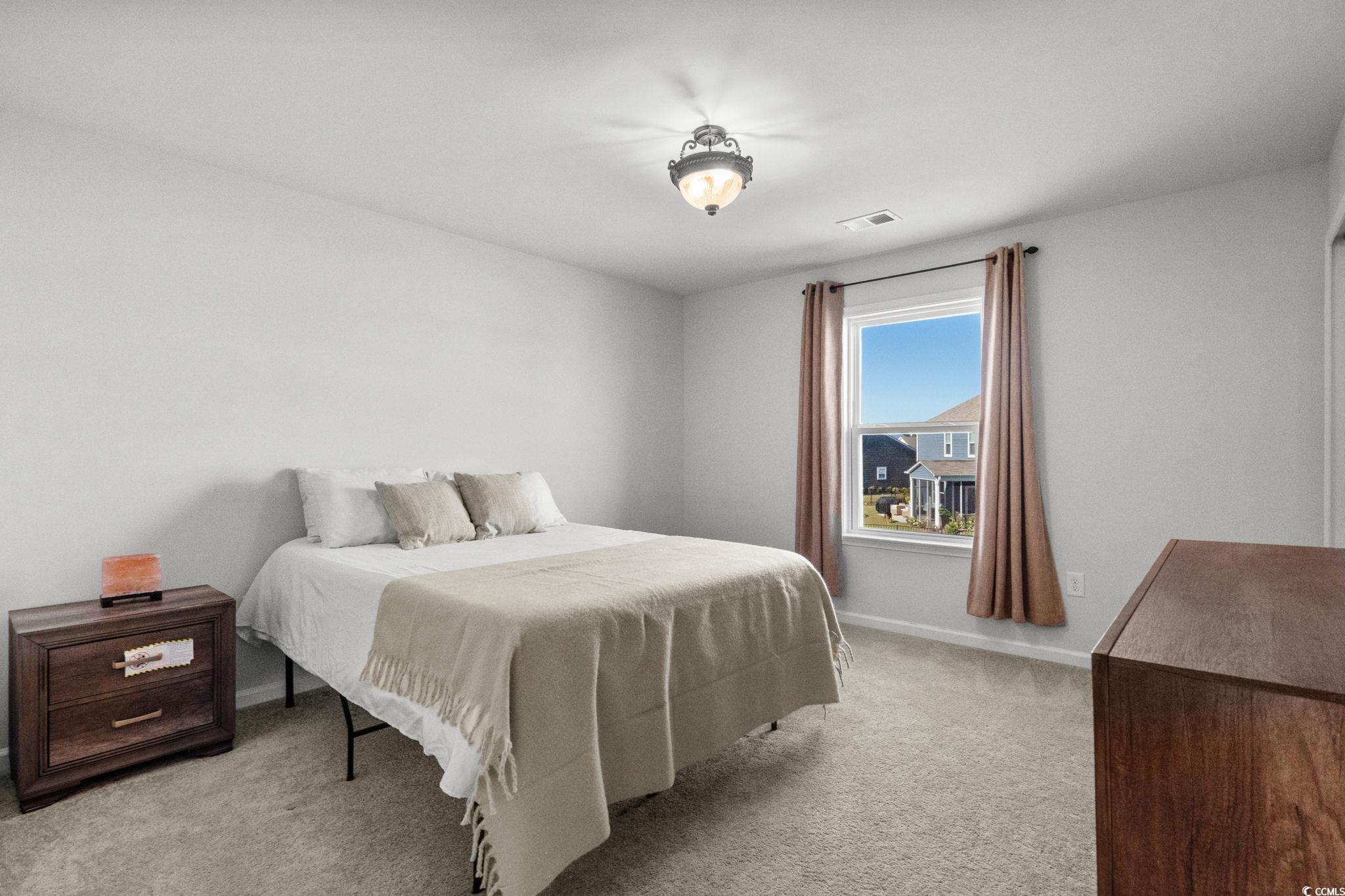 1663 Villena Drive Myrtle Beach, SC 29579 - Photo 26 of 40 Bedroom featuring light carpet and baseboards