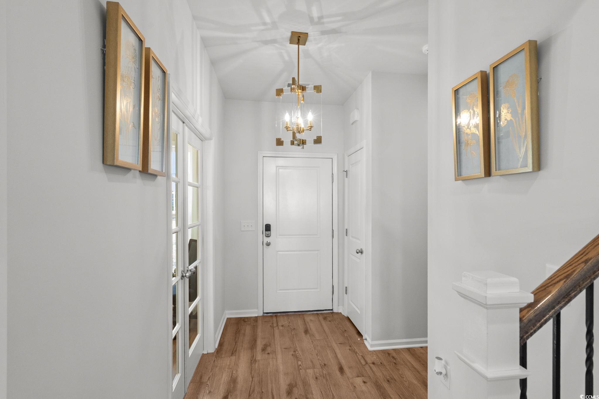 1663 Villena Drive Myrtle Beach, SC 29579 - Photo 3 of 40 Foyer entrance featuring wood finished floors and a chandelier