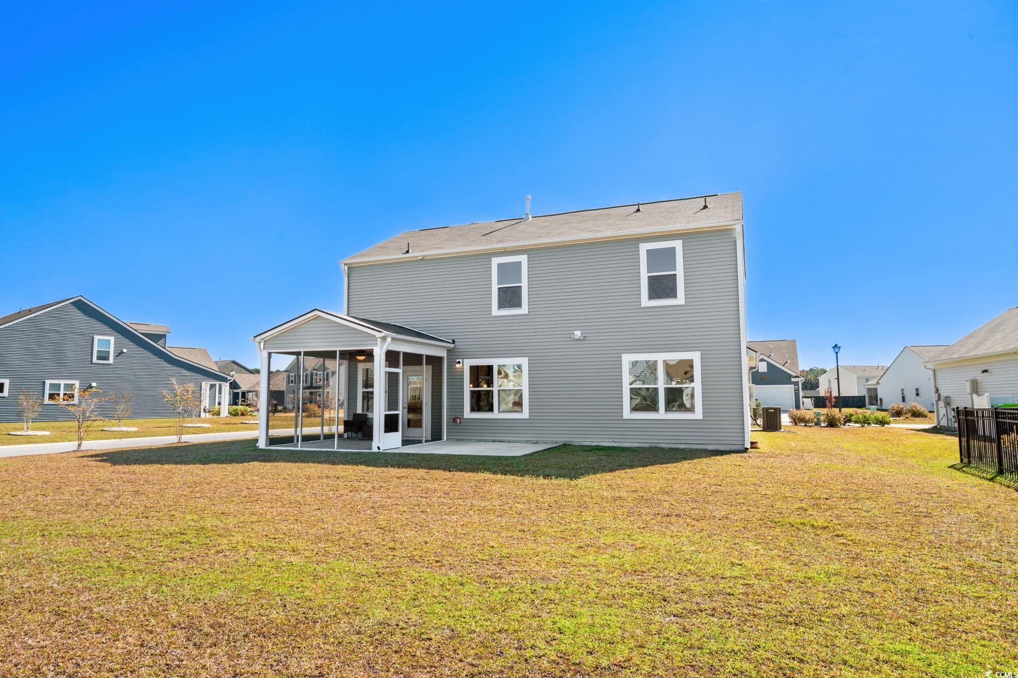1663 Villena Drive Myrtle Beach, SC 29579 - Photo 34 of 40 Back of property with a yard, a sunroom, and a patio