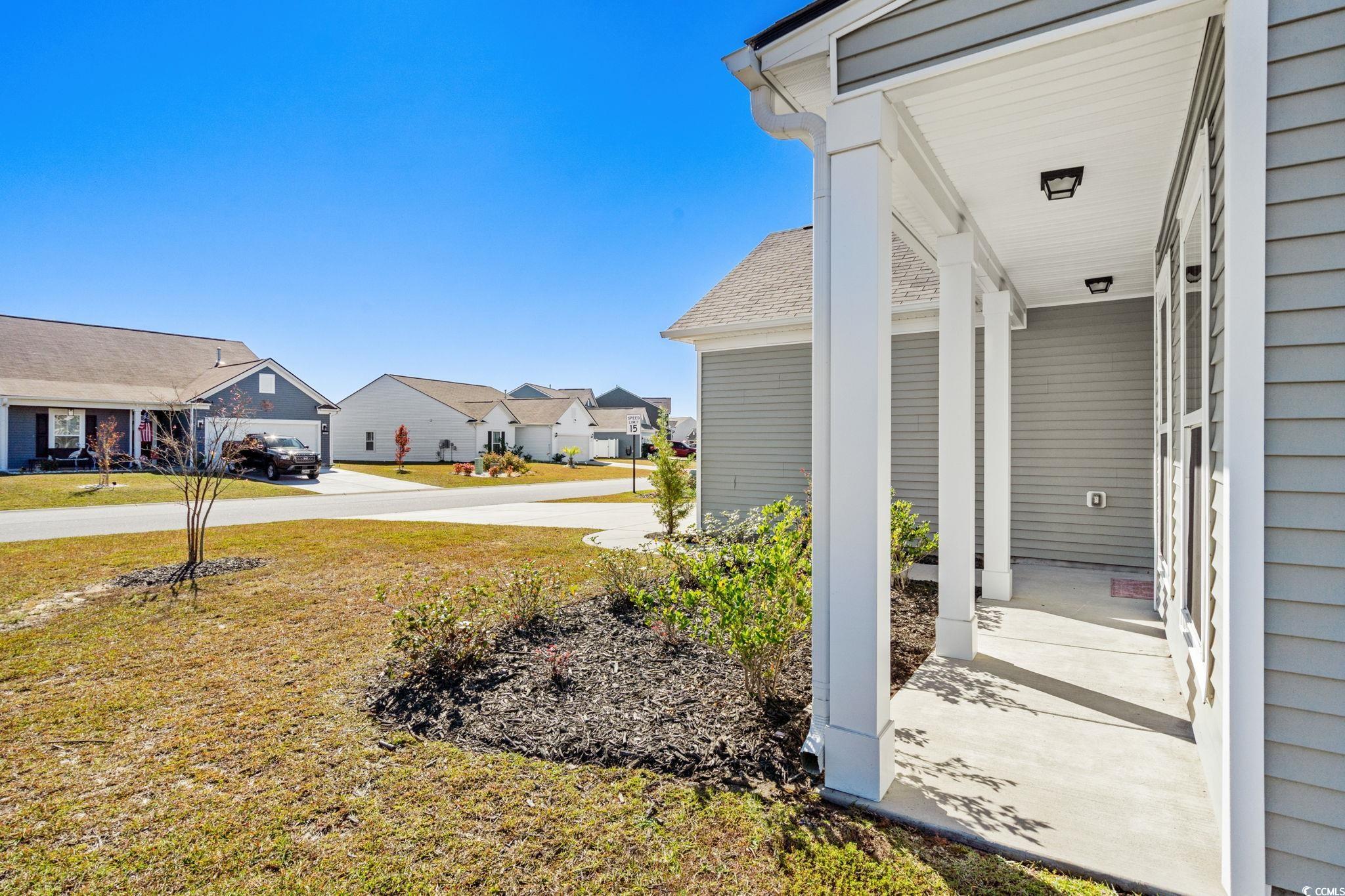 1663 Villena Drive Myrtle Beach, SC 29579 - Photo 35 of 40 View of grassy yard with a porch and a residential view