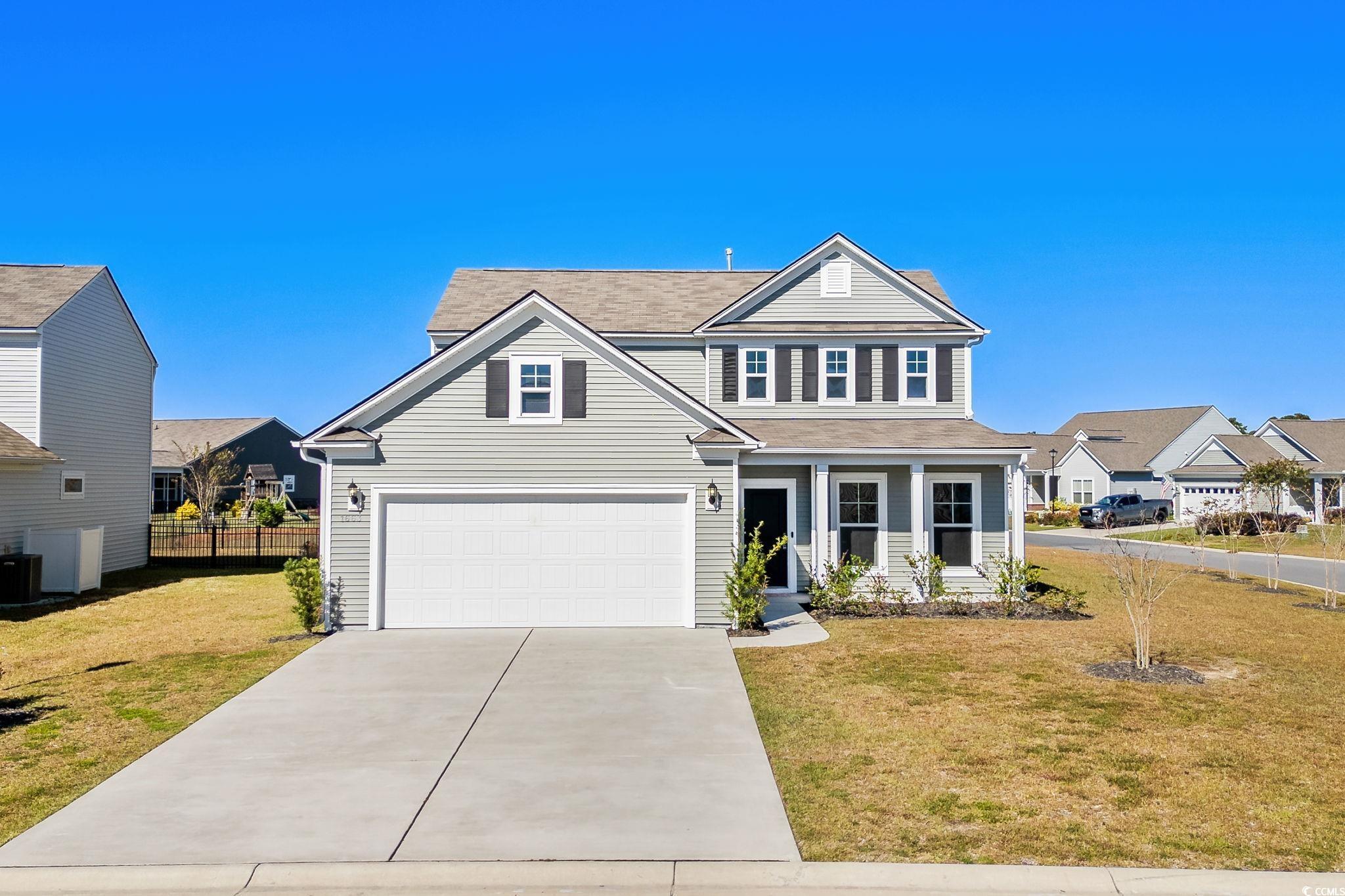 1663 Villena Drive Myrtle Beach, SC 29579 - Photo 36 of 40 Traditional home featuring covered porch, driveway, and a garage