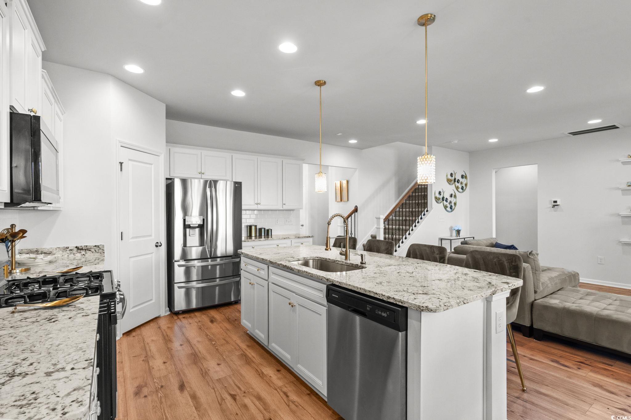 1663 Villena Drive Myrtle Beach, SC 29579 - Photo 40 of 40 Kitchen with light wood-style floors, open floor plan, appliances with stainless steel finishes, decorative light fixtures, and recessed lighting