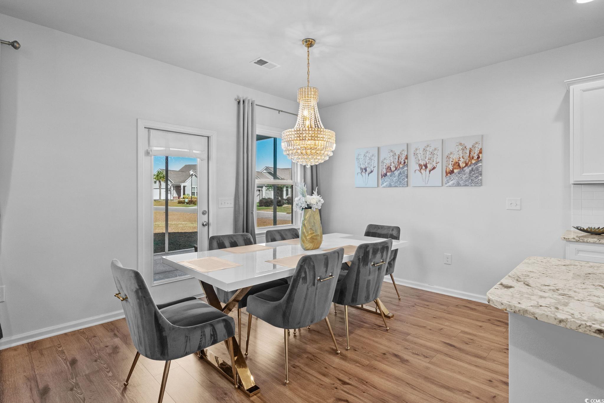 1663 Villena Drive Myrtle Beach, SC 29579 - Photo 6 of 40 Dining area with light wood-type flooring and a chandelier
