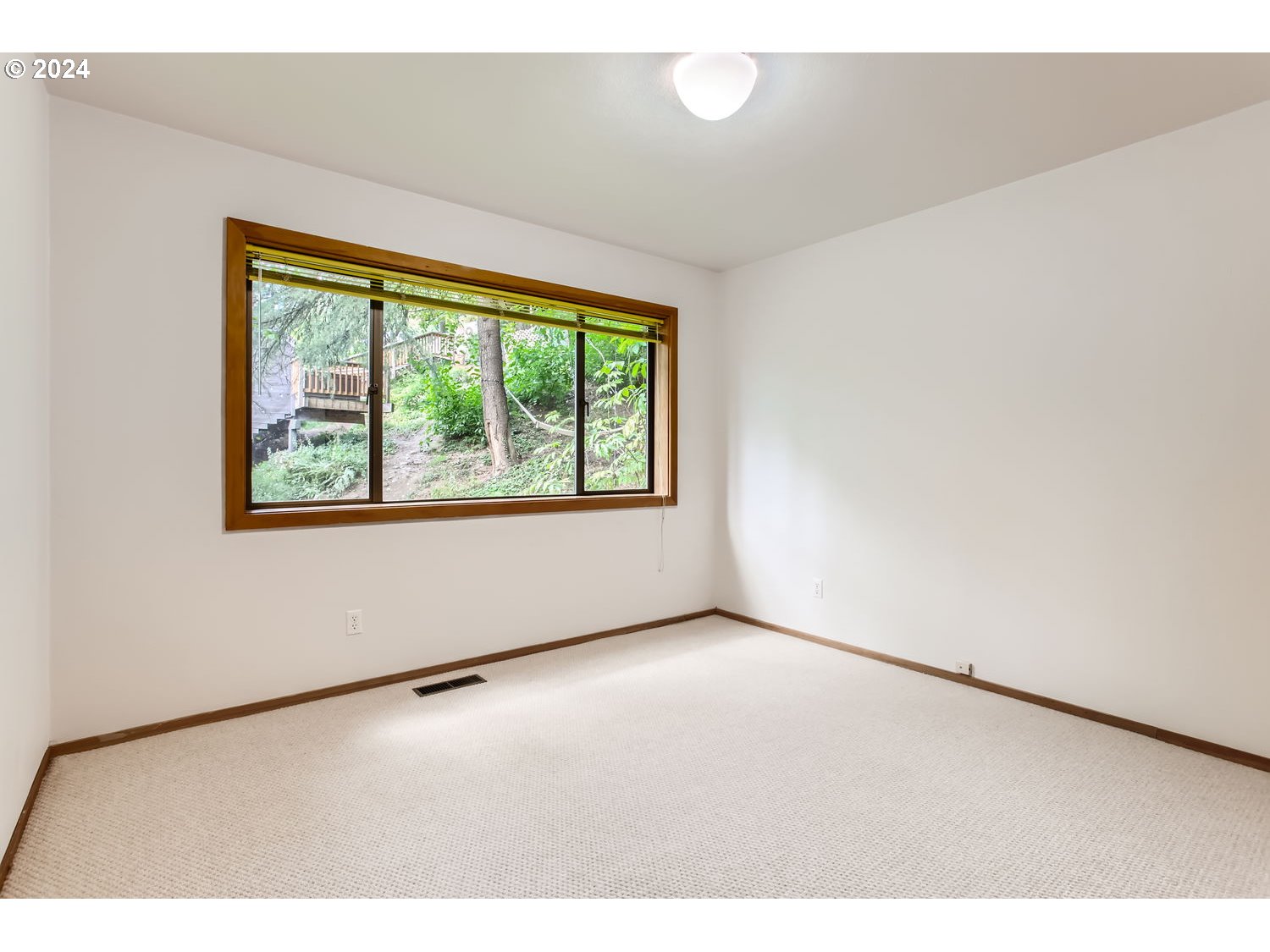 3831 Southwest Dosch Road Portland, OR 97239 - Photo 21 of 29 a view of an empty room with a window