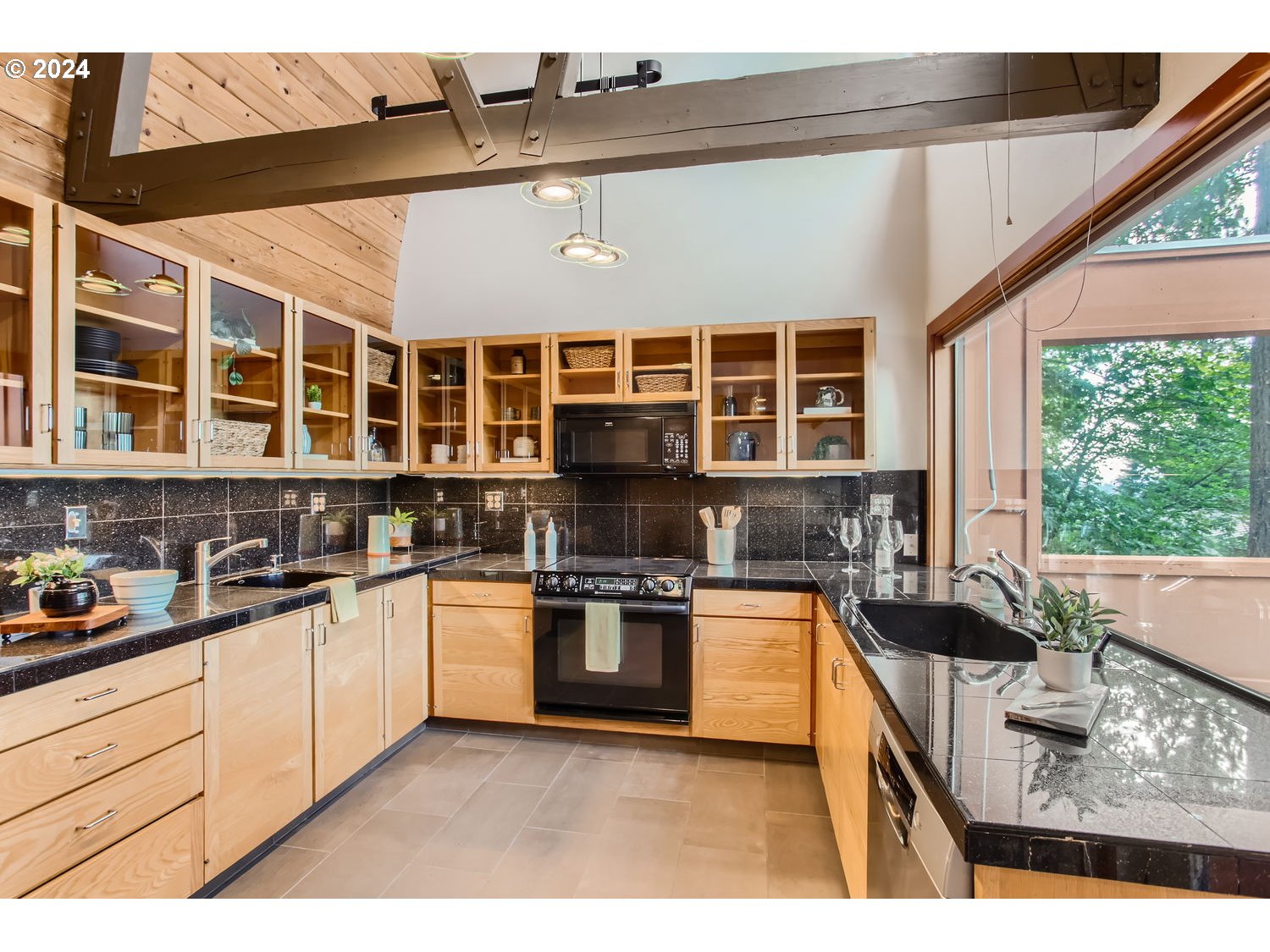 3831 Southwest Dosch Road Portland, OR 97239 - Photo 7 of 29 a kitchen with stainless steel appliances granite countertop a stove a sink and a microwave
