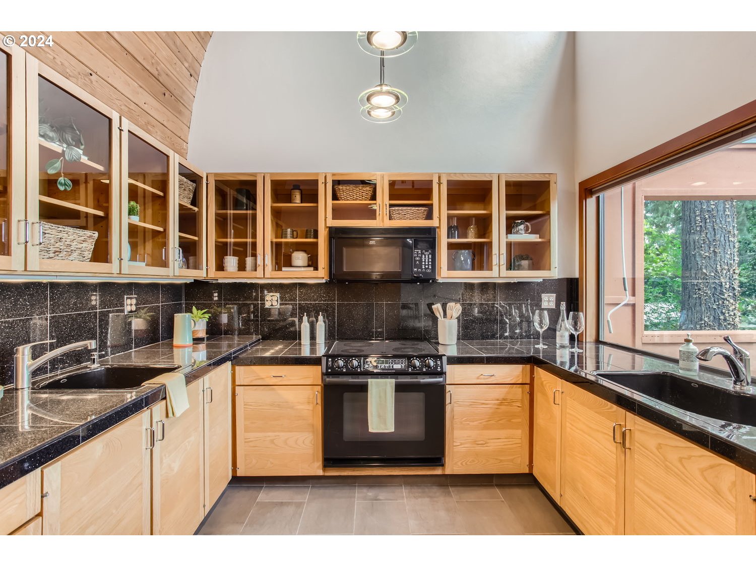 3831 Southwest Dosch Road Portland, OR 97239 - Photo 8 of 29 a kitchen with a stove top oven and sink