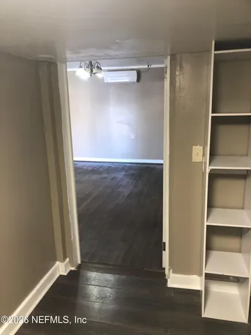 a view of a room with wooden floor