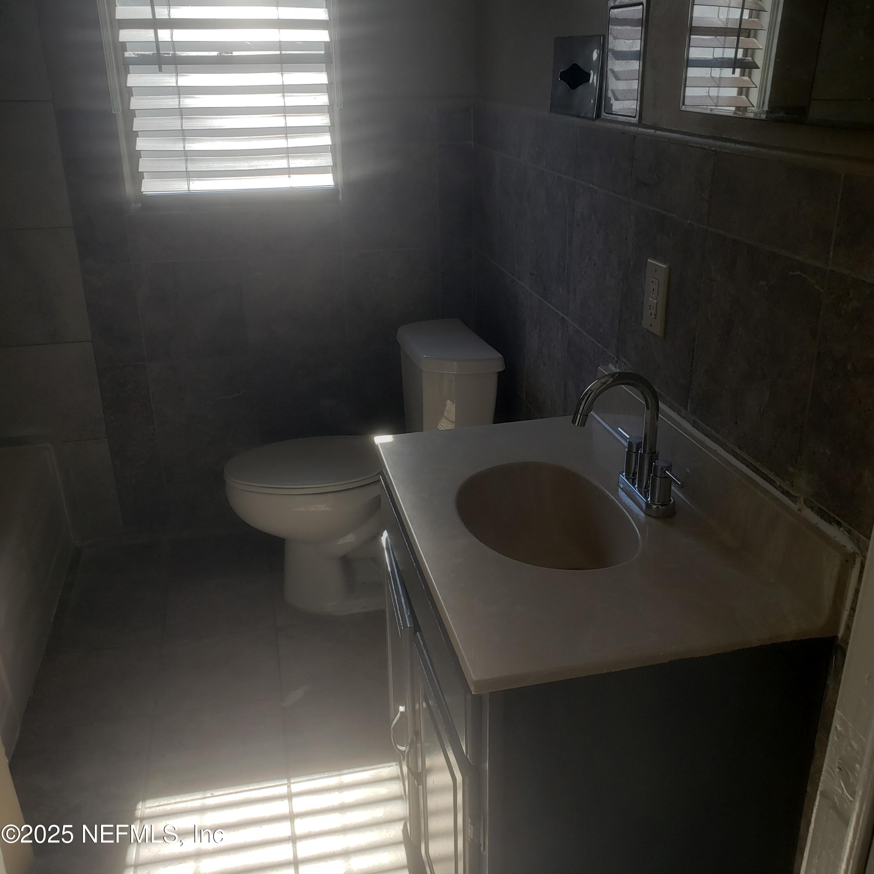 3034 Post Street Jacksonville, FL 32205 - Photo 8 of 12 a bathroom with a toilet sink and window