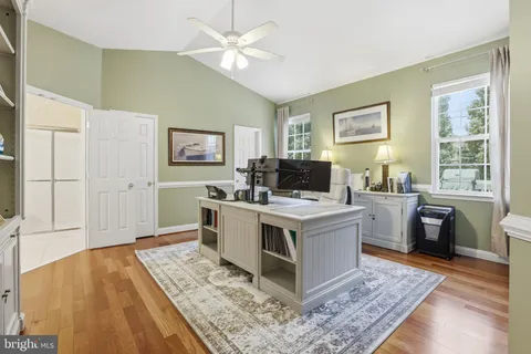 a kitchen with a stove and wooden floor