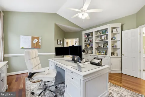 a view of a workspace with furniture and a bookshelf