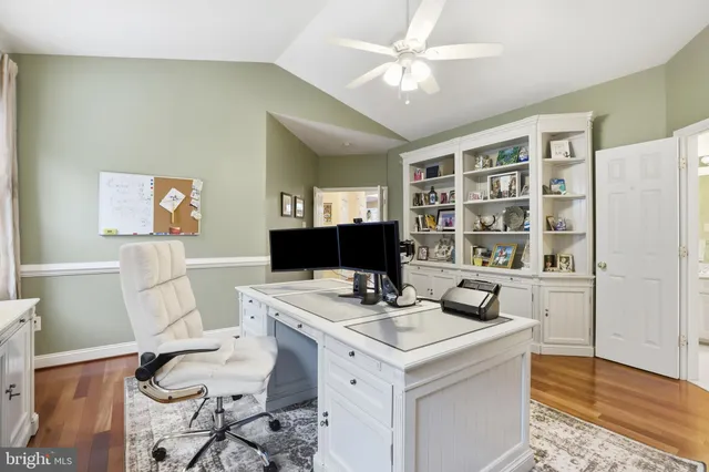 a view of a workspace with furniture and a bookshelf
