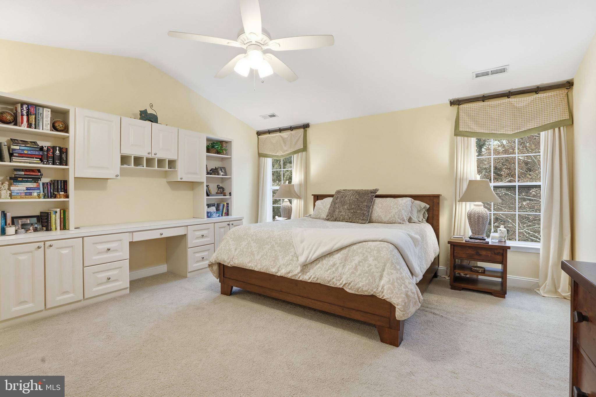 1612 Trawler Lane Annapolis, MD 21409 - Photo 23 of 48 a spacious bedroom with a large bed and a chandelier