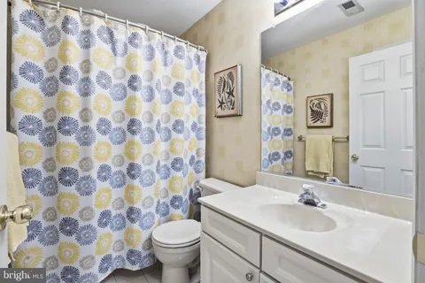 a bedroom with a bed and a ceiling fan