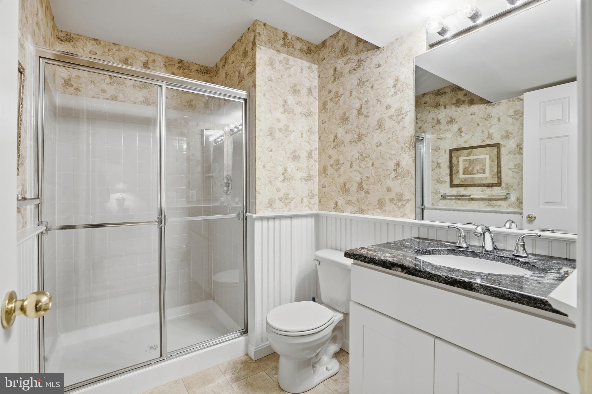 1612 Trawler Lane Annapolis, MD 21409 - Photo 39 of 48 a bathroom with a granite countertop sink toilet and shower