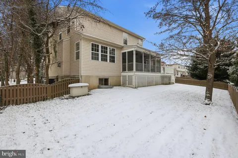a front view of house with yard and trees in the background
