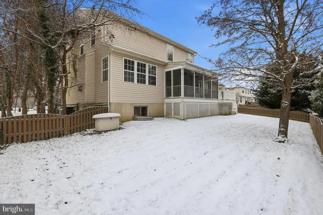 a front view of house with yard and trees in the background