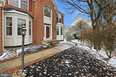 a view of yard covered with snow in front of building