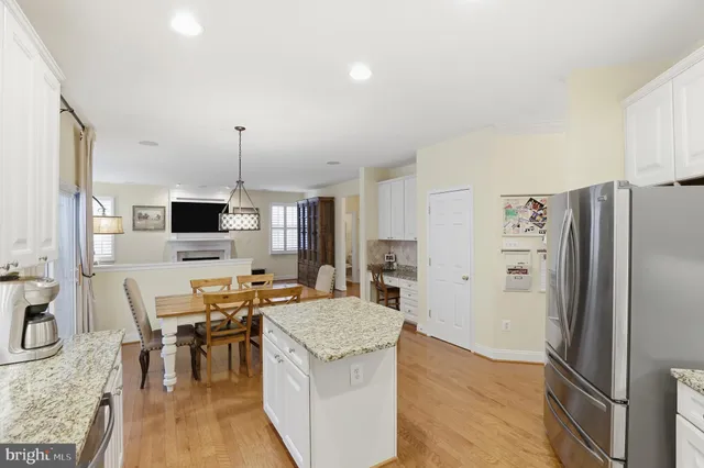 a kitchen with stainless steel appliances granite countertop a refrigerator stove microwave and sink