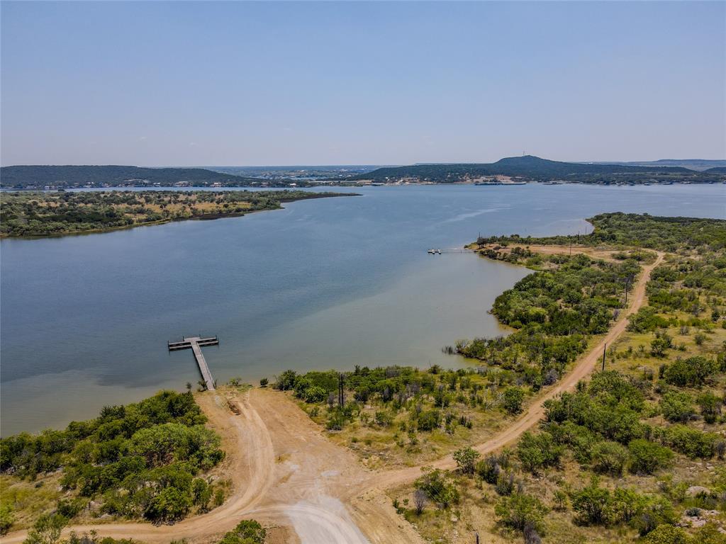 Lot 112 Clearwater Point Graham, TX 76450 - Photo 8 of 13 a view of a lake with houses in the back