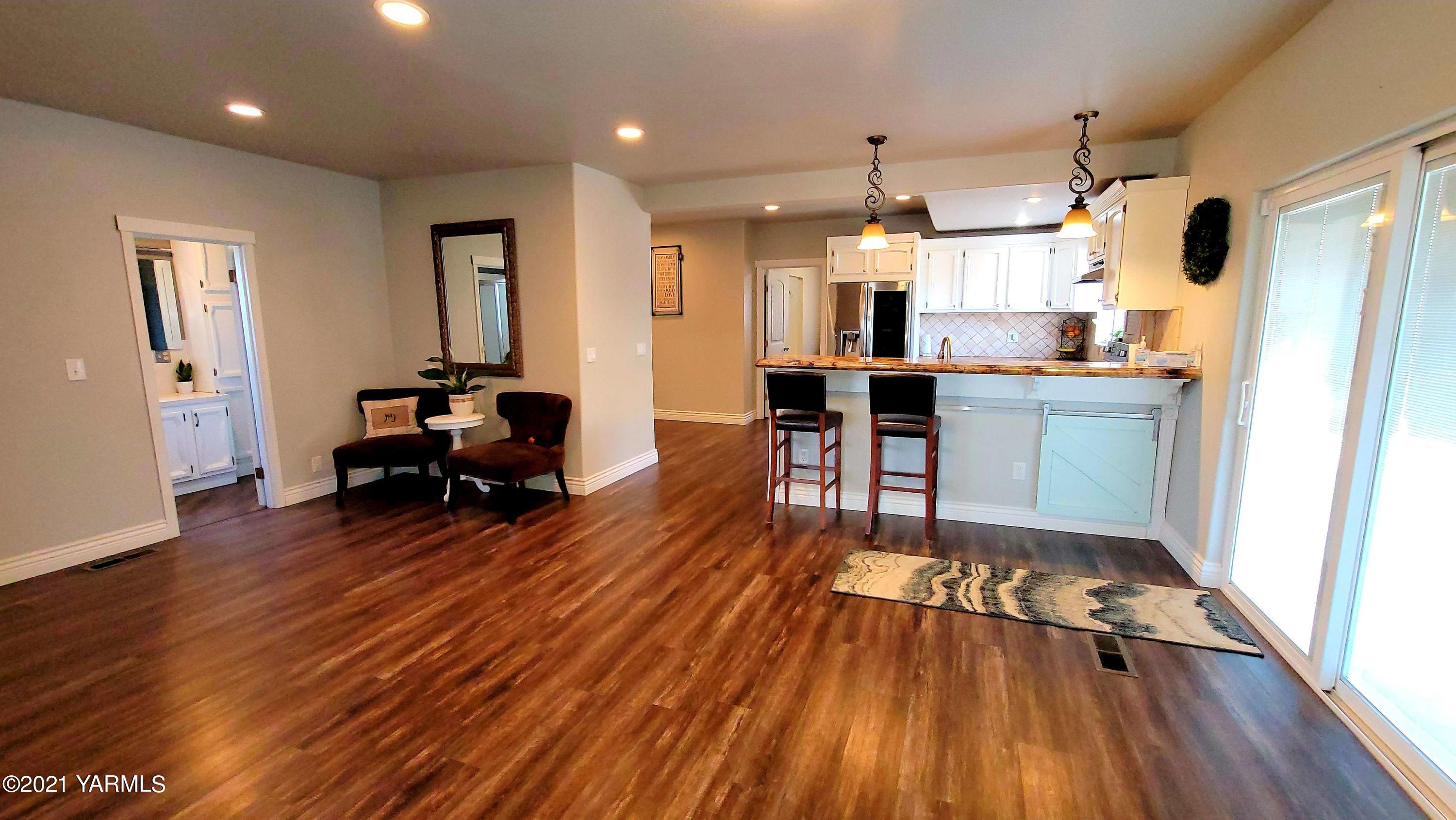 1141 Alexander Road Sunnyside, WA 98944 - Photo 7 of 16 a living room with furniture and a wooden floor