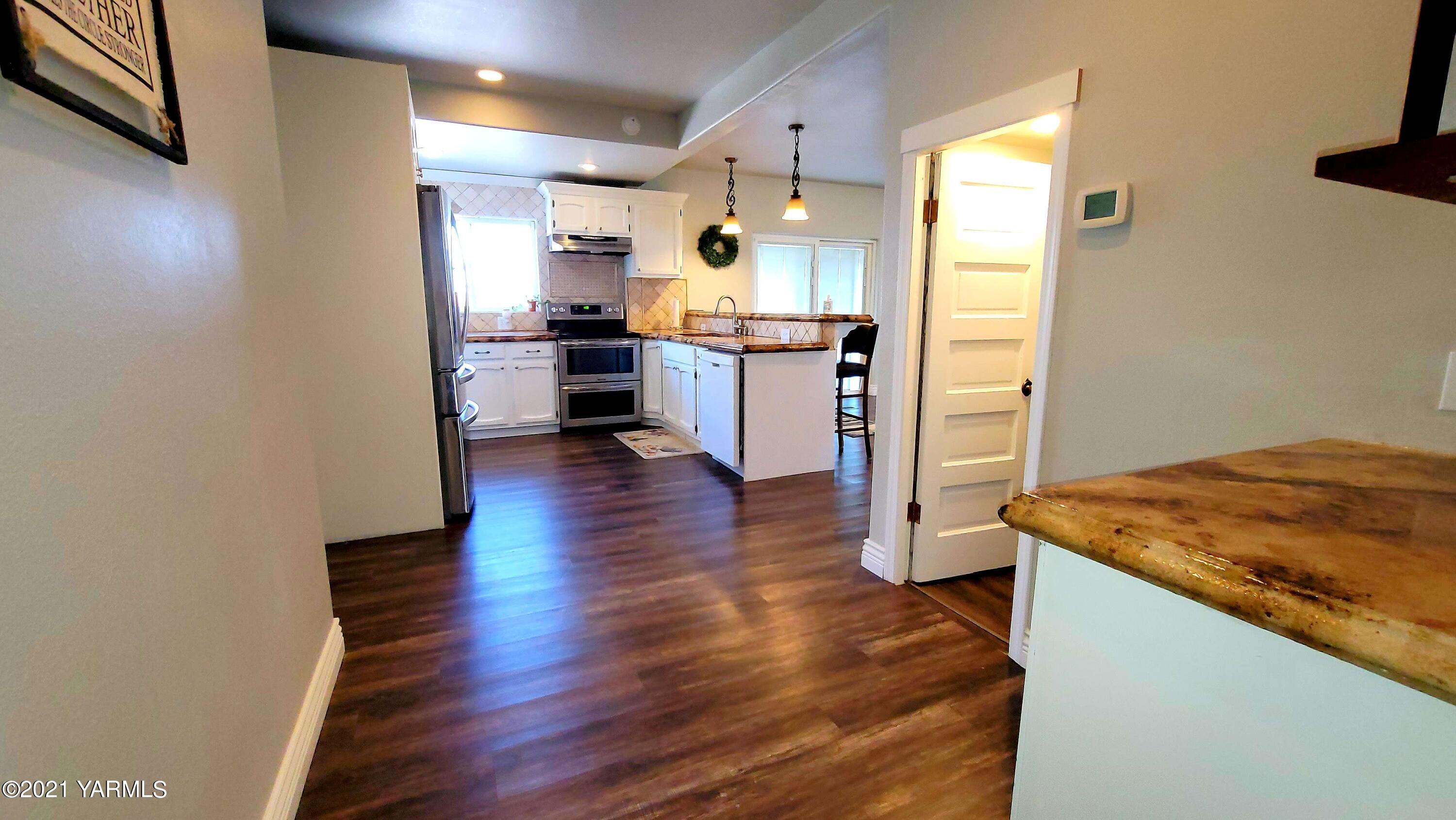 1141 Alexander Road Sunnyside, WA 98944 - Photo 9 of 16 a kitchen with a sink and a refrigerator