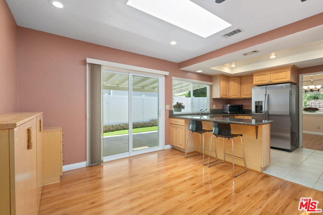 1463 Morrow Circle Thousand Oaks, CA 91362 - Photo 11 of 25 a kitchen with stainless steel appliances a refrigerator and wooden floor