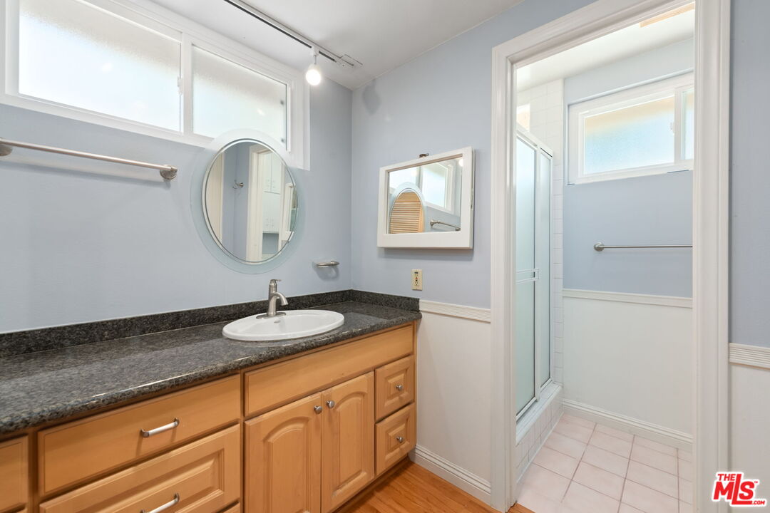 1463 Morrow Circle Thousand Oaks, CA 91362 - Photo 16 of 25 a bathroom with a granite countertop sink a mirror and a vanity