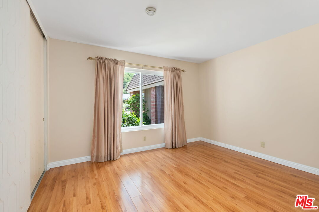 1463 Morrow Circle Thousand Oaks, CA 91362 - Photo 18 of 25 a view of an empty room with wooden floor and a window