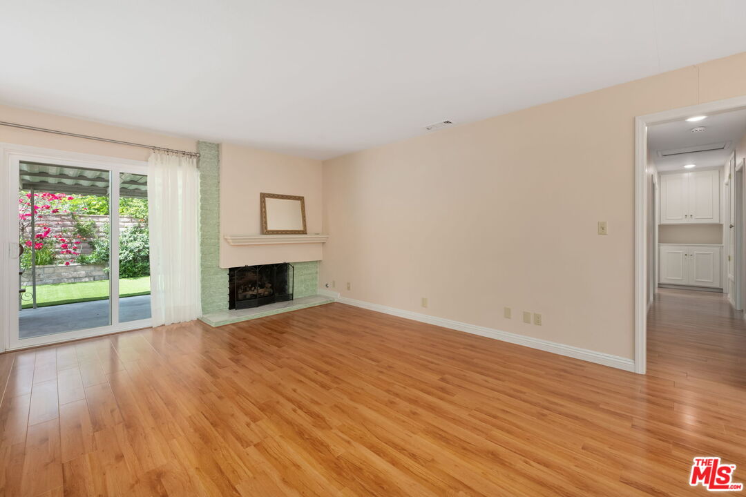 1463 Morrow Circle Thousand Oaks, CA 91362 - Photo 5 of 25 a view of empty room with wooden floor and fireplace