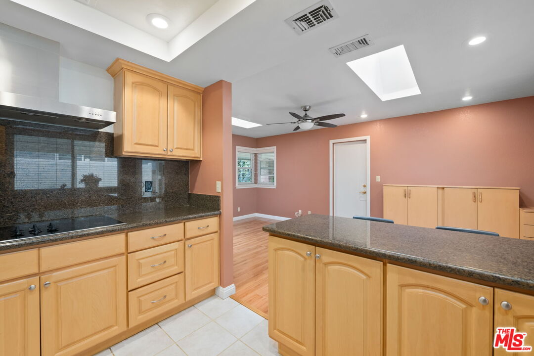 1463 Morrow Circle Thousand Oaks, CA 91362 - Photo 9 of 25 a large kitchen with granite countertop a sink a window and stainless steel appliances