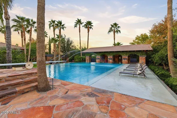 a view of a house with garden and patio