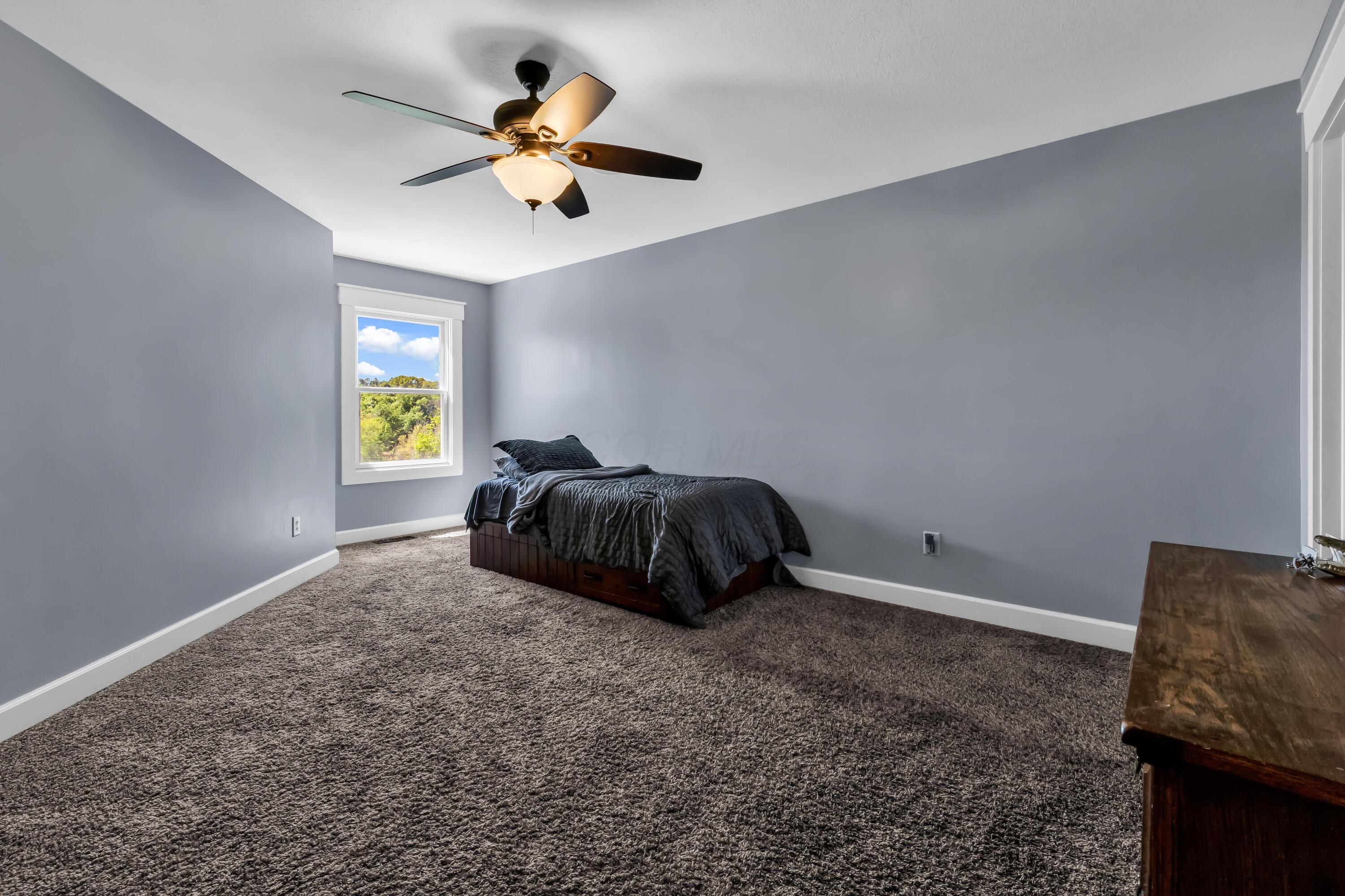 16689 Bailor Road Laurelville, OH 43135 - Photo 32 of 73 • Light sand carpet
• Grey painted walls
• Lighted ceiling fan
• Jack & Jill bath